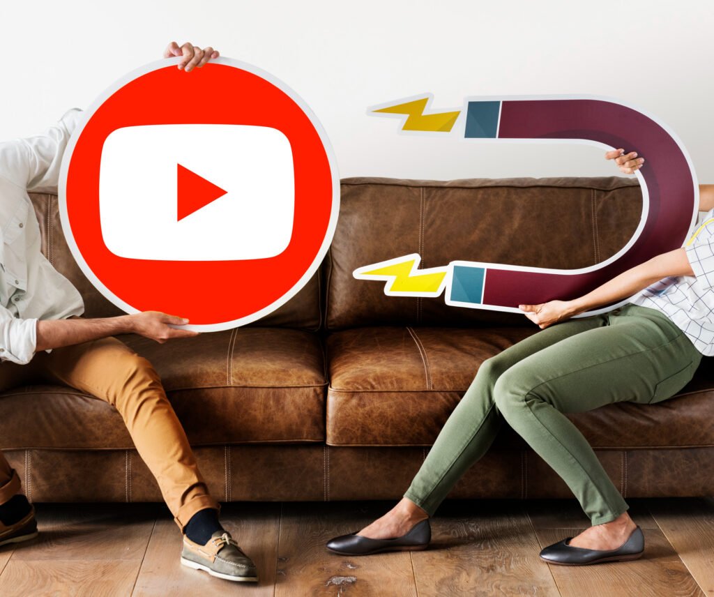 Deux personnes tenant une icône YouTube et un aimant, illustrant l’importance du référencement et de l’engagement pour le SEO des vidéos YouTube.